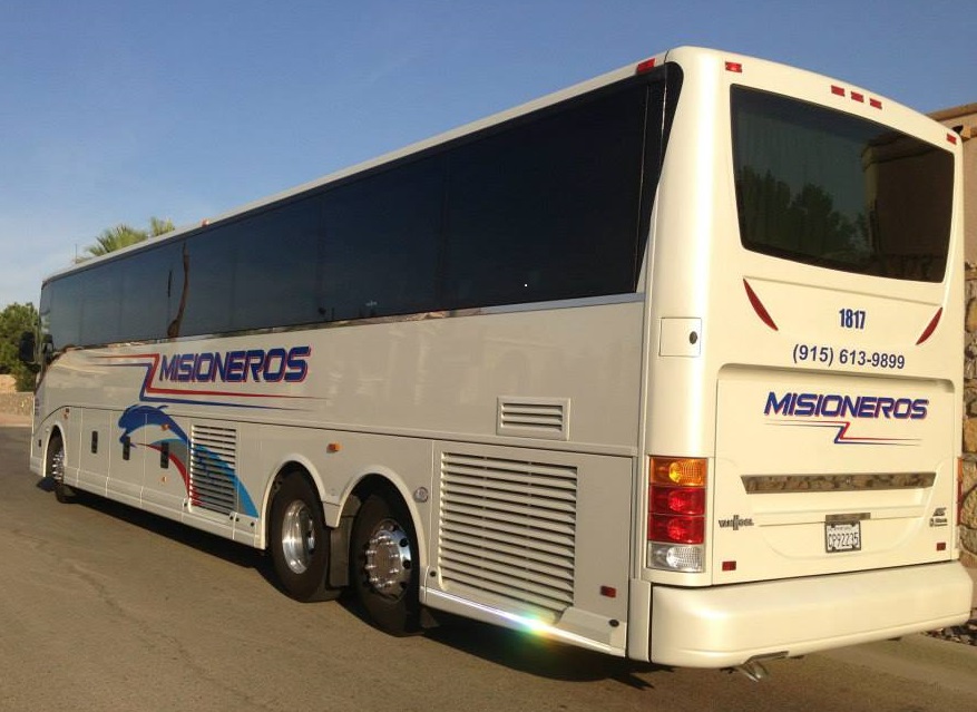 back view of misioneros white charter bus